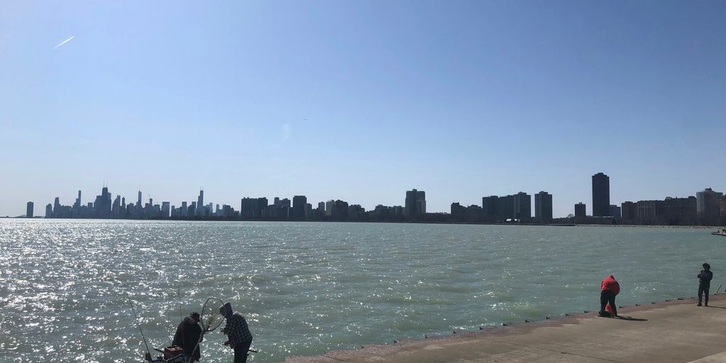 a group of people standing next to a body of water