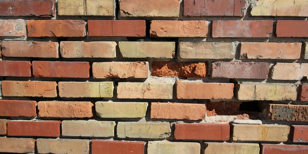 a close up of a brick wall with a hole in it