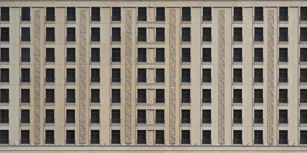 a tall building with many windows and a clock