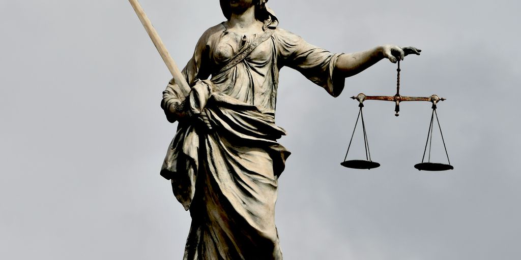 A statue of lady justice holding a sword and a scale