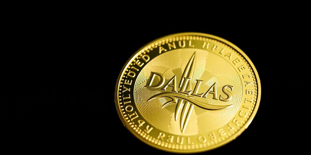 Close-up of a gold coin on dark velvet fabric.