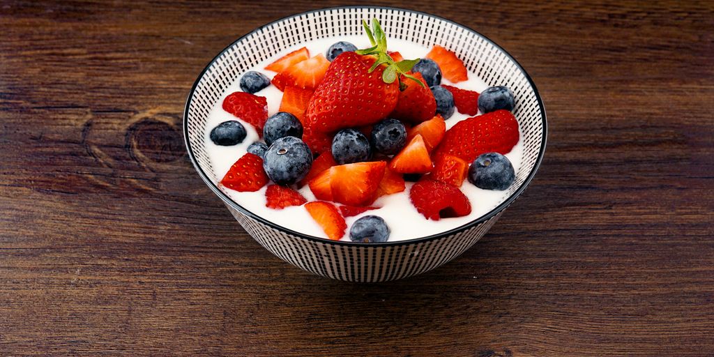 strawberry and blackberries on top of brown table