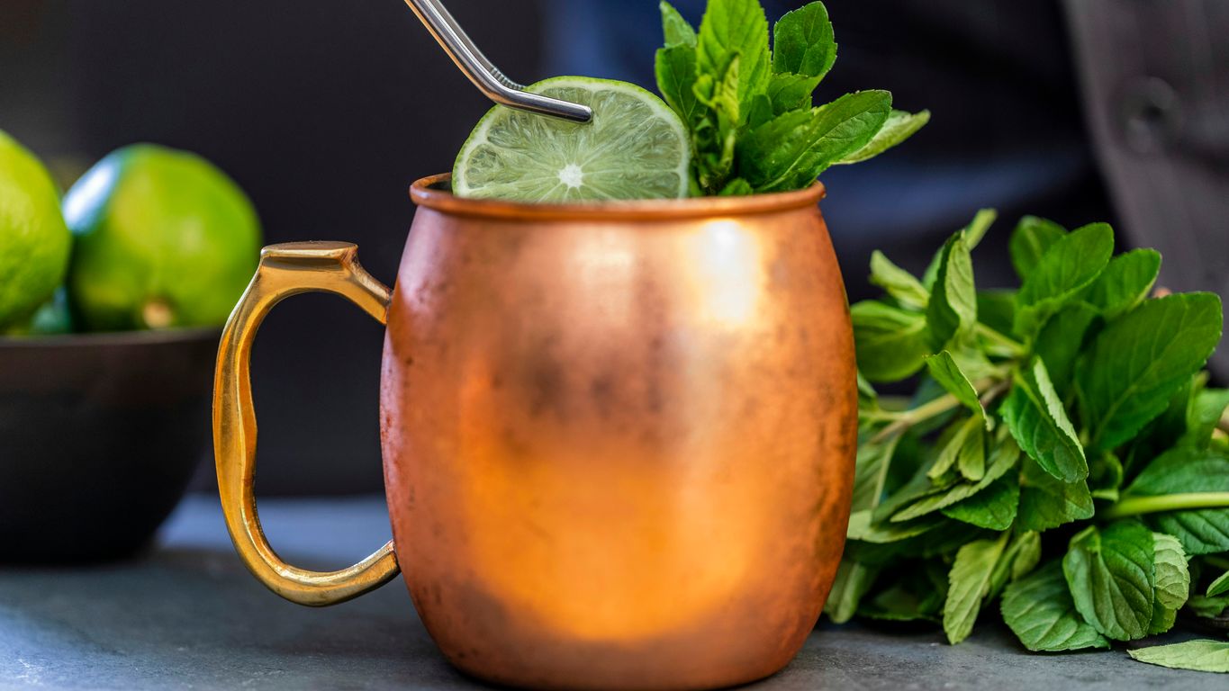 brass-colored mug with sliced lime