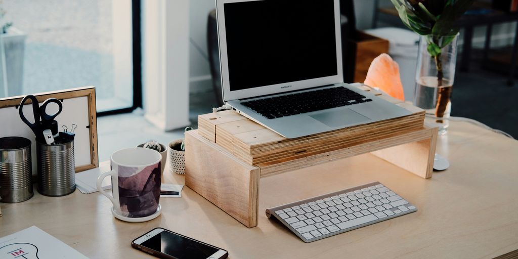 silver MacBook on desk