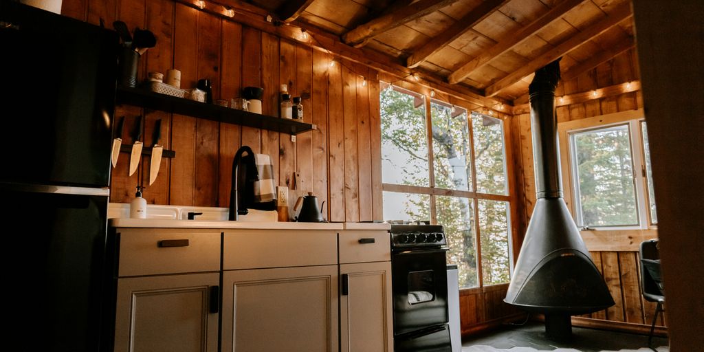 a kitchen with a stove top oven next to a window