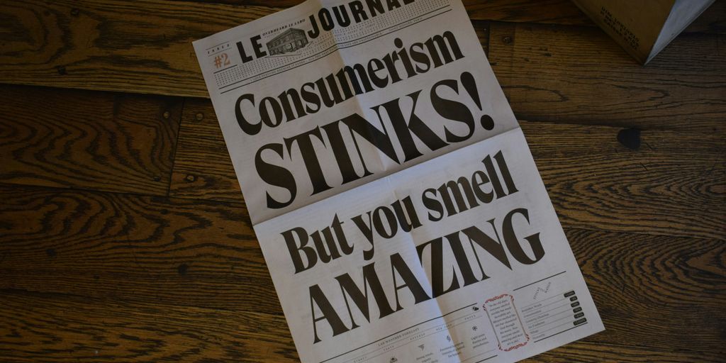 Le Journal newspaper page on wooden surface