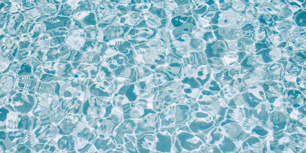 a pool with clear blue water and bubbles
