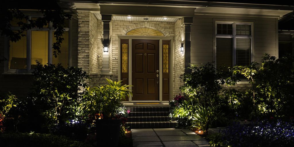 Motion sensor lights illuminating a home's entrance at night.