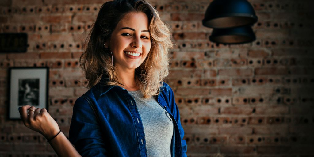 woman standing near pendant lamp