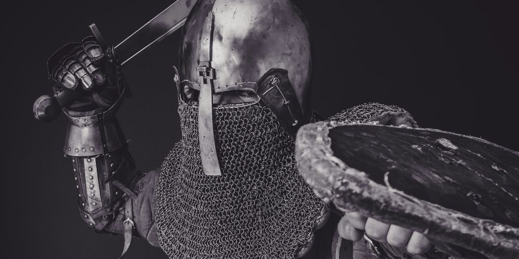 man with steel and chainmail armor holding sword