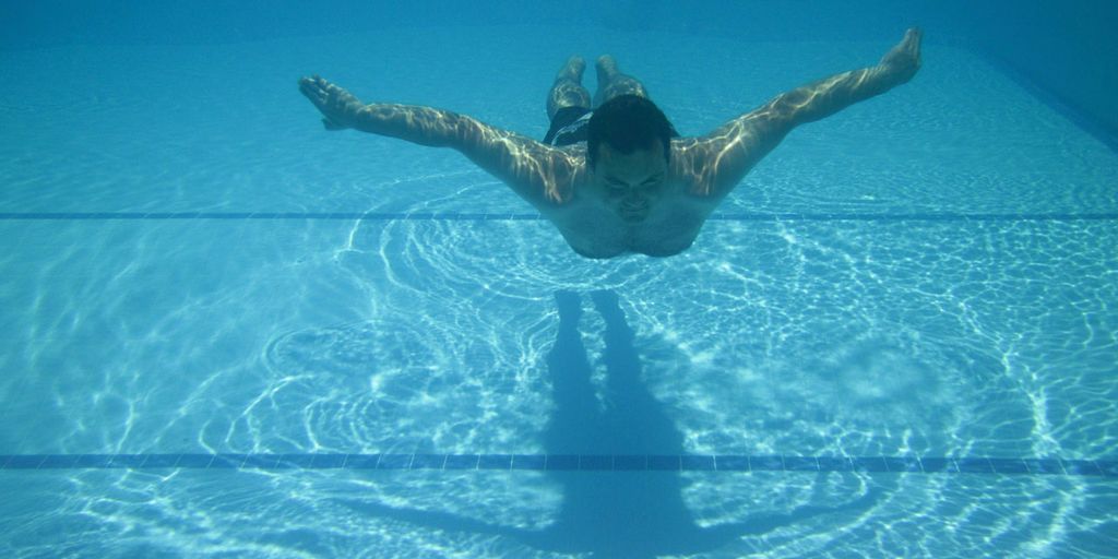 swimmer eating banana poolside