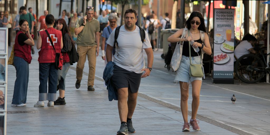 A group of people walking down a street