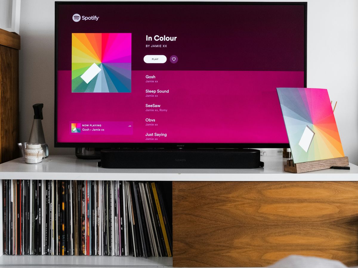 a flat screen tv sitting on top of a white shelf