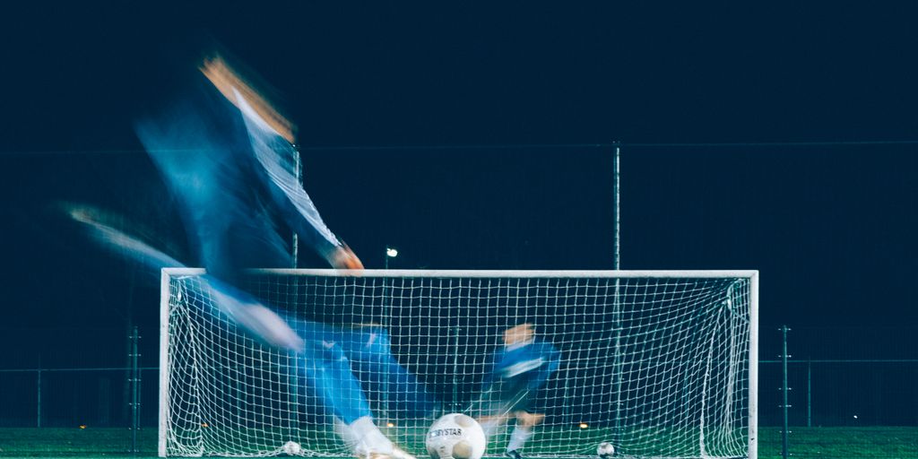 timelapse photo of soccer player kicking ball