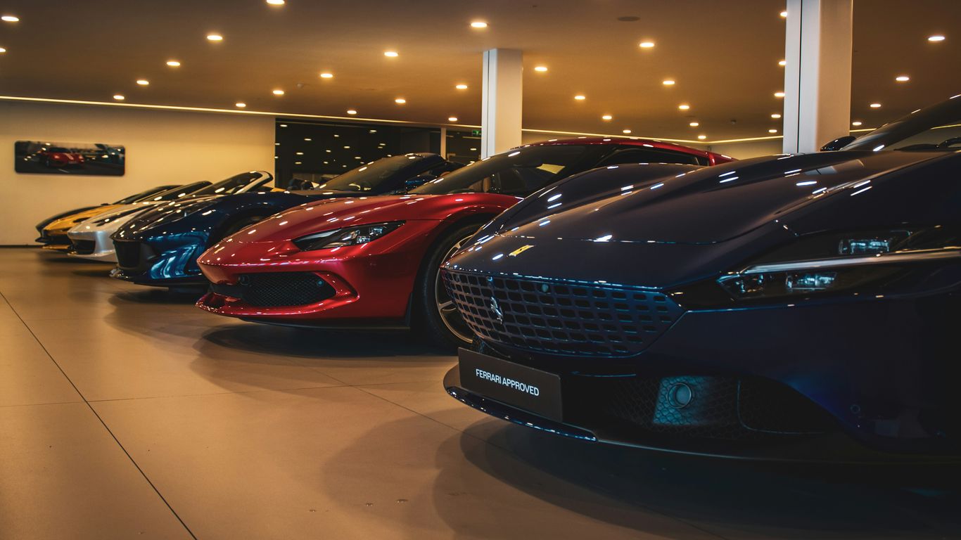 A bunch of cars are parked in a showroom