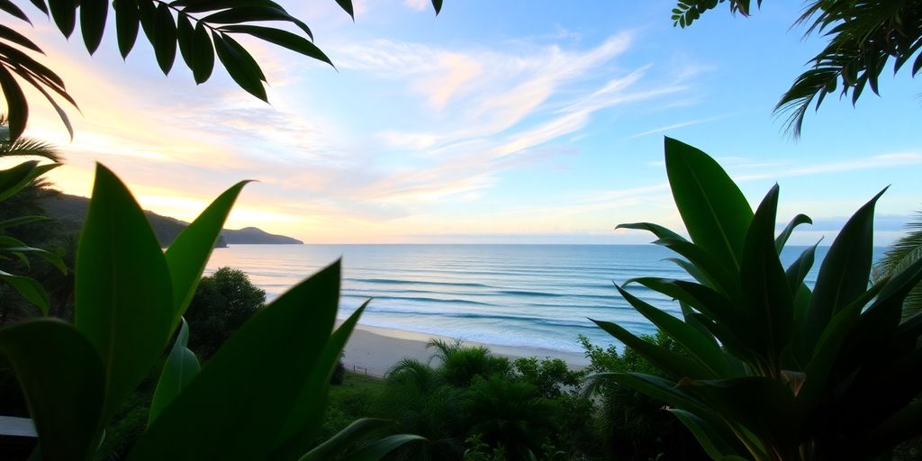 Beachfront property in Phuket with lush greenery and sunset.