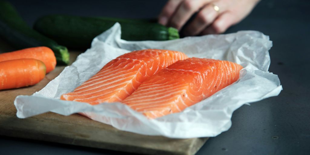 raw fish meat on brown chopping board