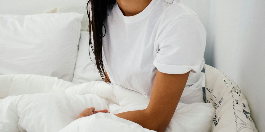 woman sitting on bed