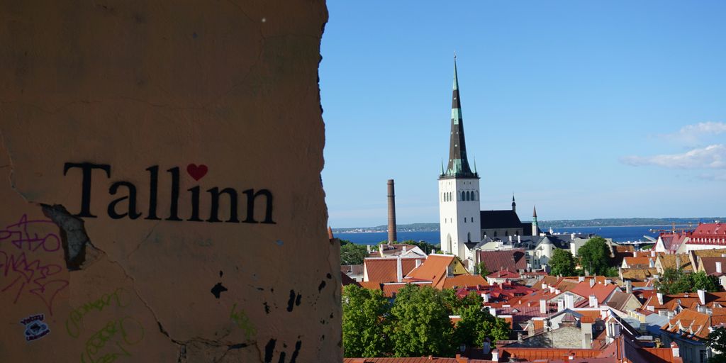 A view of a city with a steeple in the background