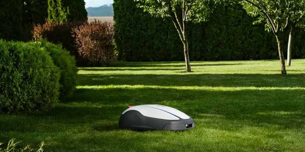 A robotic lawn mower on well-maintained green grass.