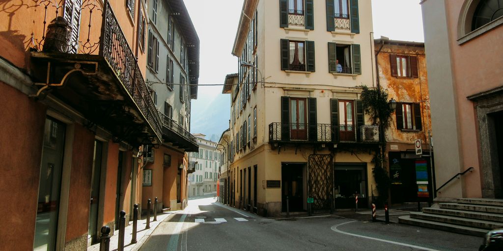 an empty street with a car parked on the side of it