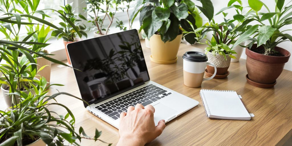 Dynamischer Arbeitsplatz mit Laptop und Notizbuch.