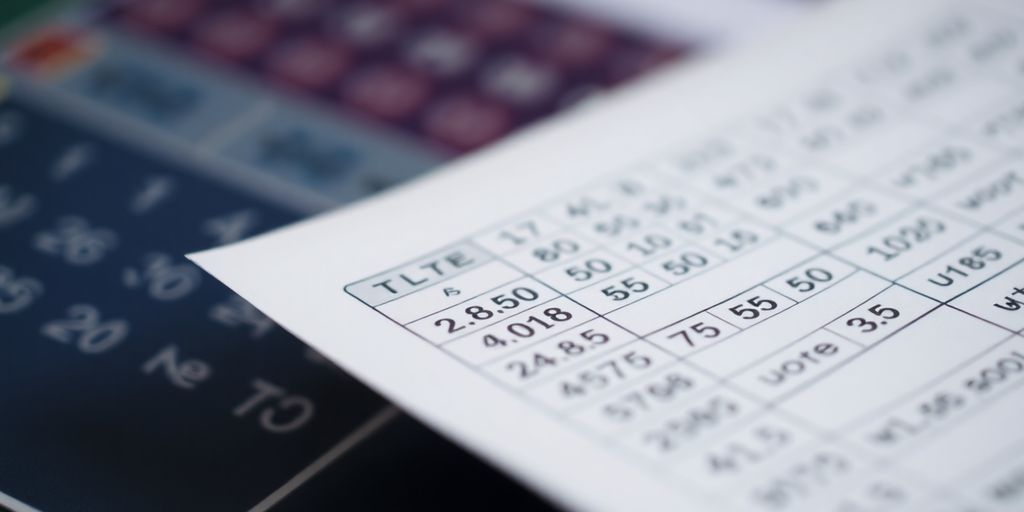 Person studying a betting slip with focused eyes.