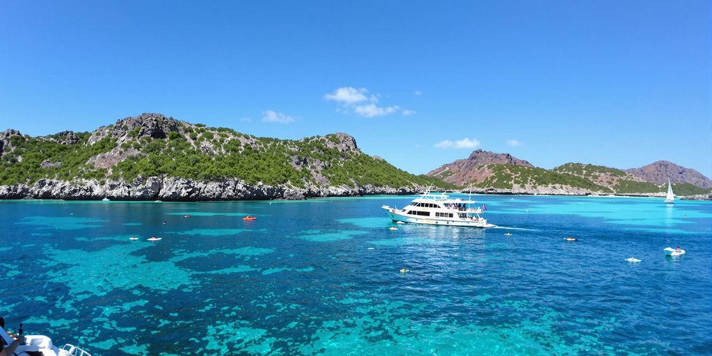 Catnazse Phinisi boat on turquoise water in Komodo.