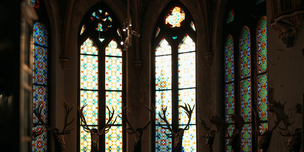 A large room with stained glass windows and a chandelier