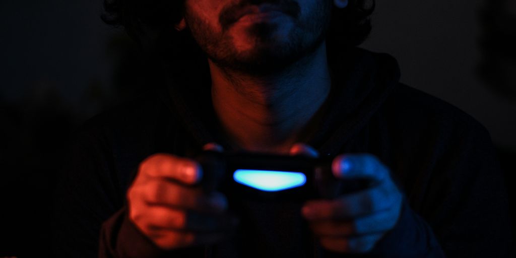man in black jacket holding black smartphone