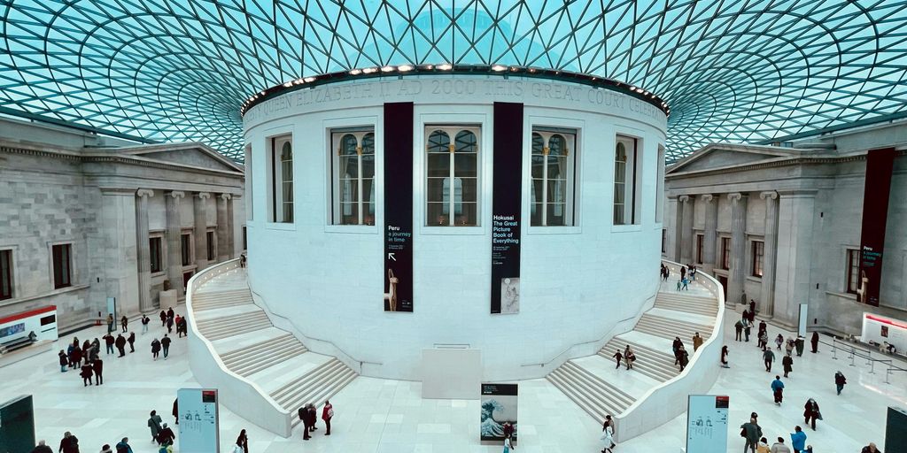 a group of people walking around inside of a building