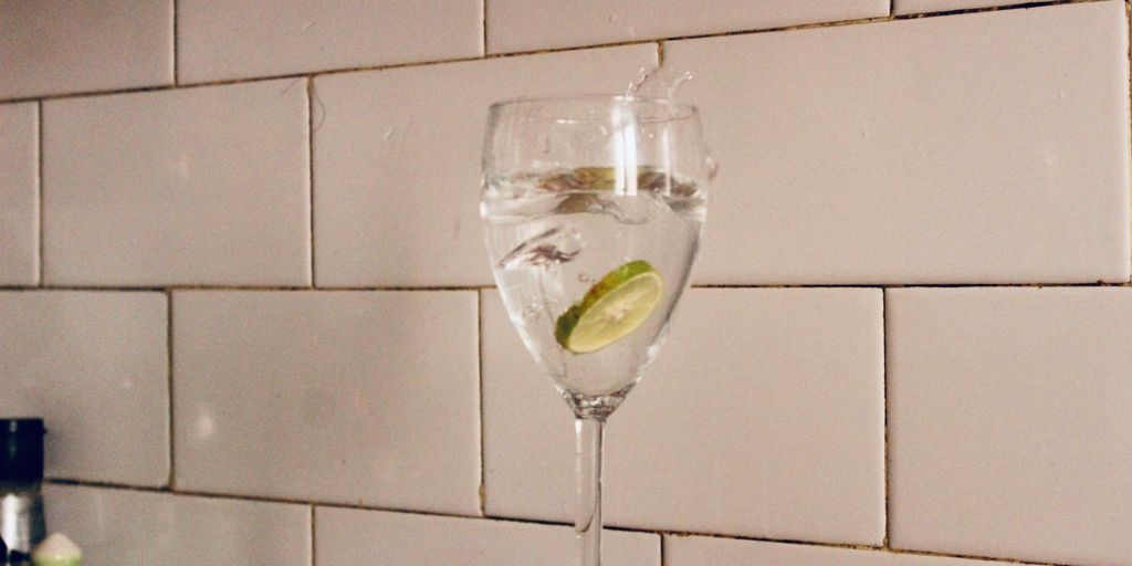 clear wine glass with green liquid inside