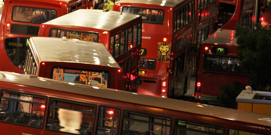 red double decker bus on road during nighttime