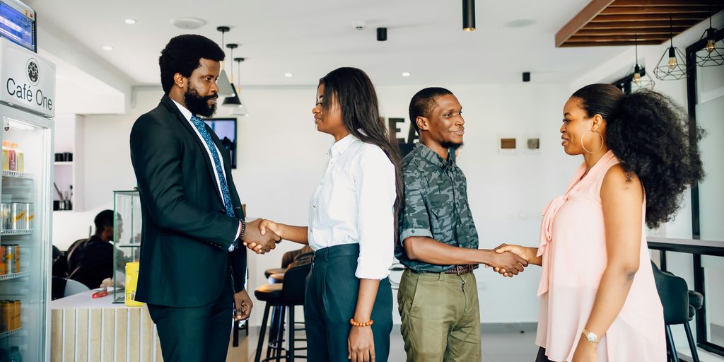 A group of people shaking hands in a room