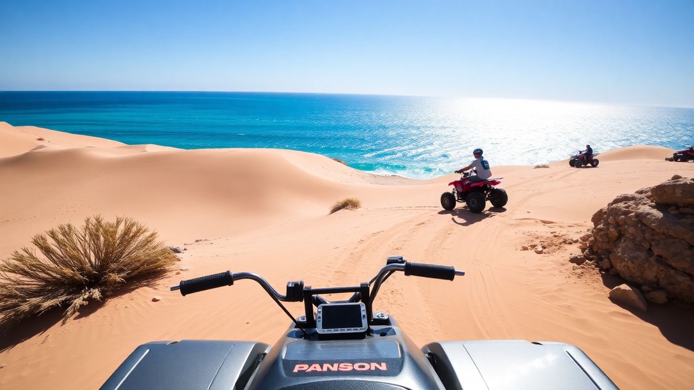 ATV on desert dune with ocean view