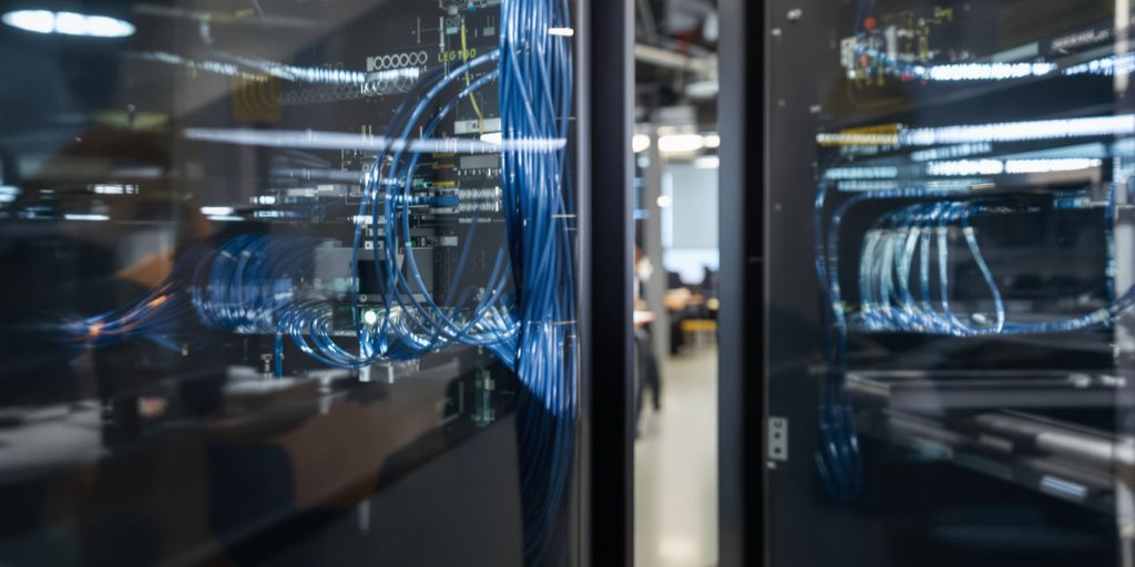 Technician installing network cables in a modern office.