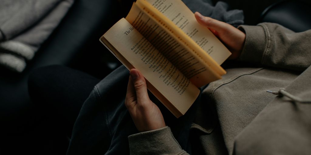 person reading book white sitting
