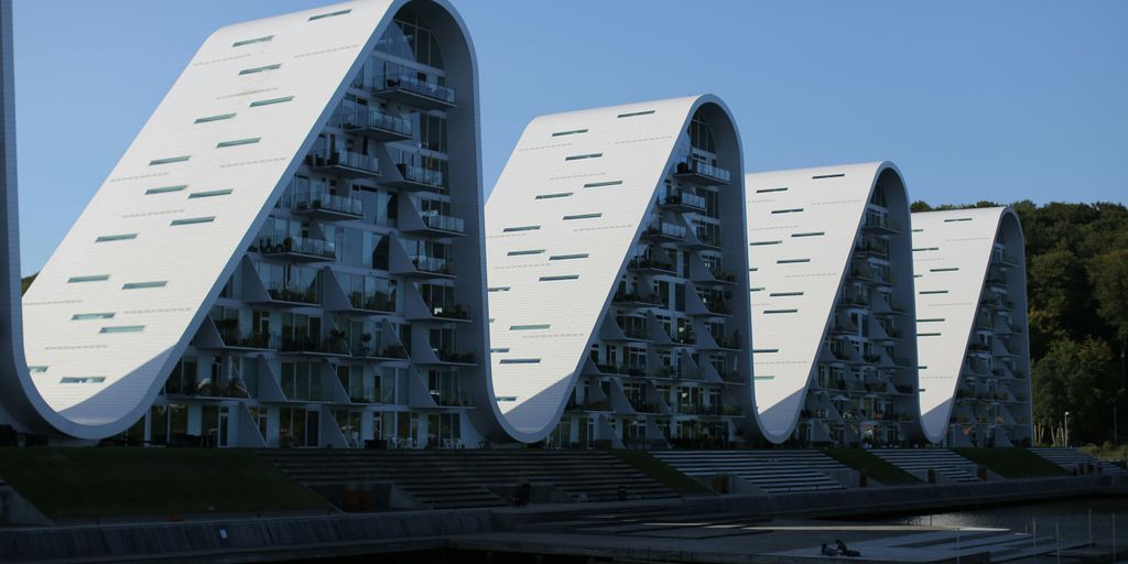a row of buildings sitting next to a body of water