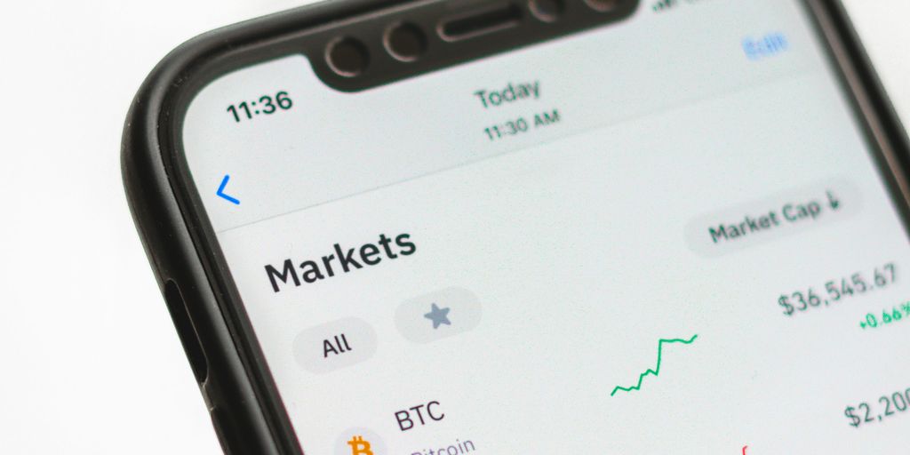 Smartphone displaying cryptocurrency market data and performance trends.