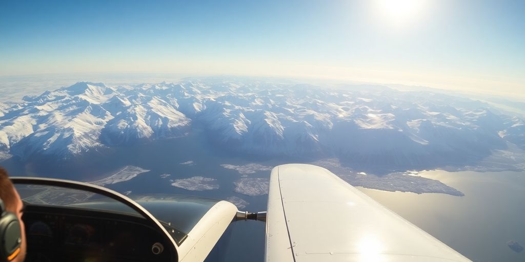 A small airplane flying over a snowy Alaskan mountain range.