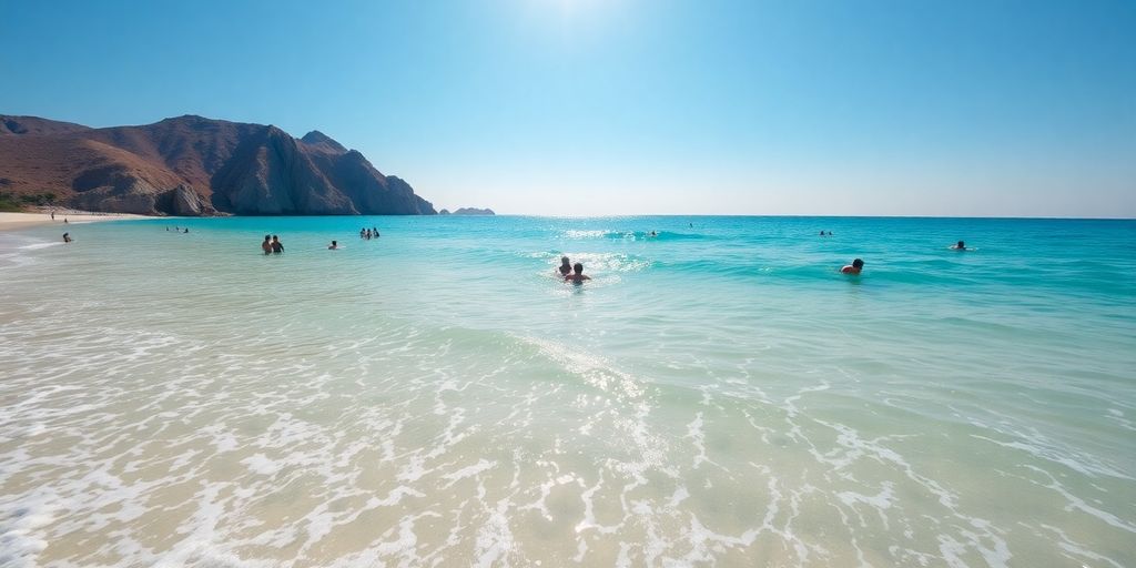 Tourists swimming in clear turquoise Cabo ocean water