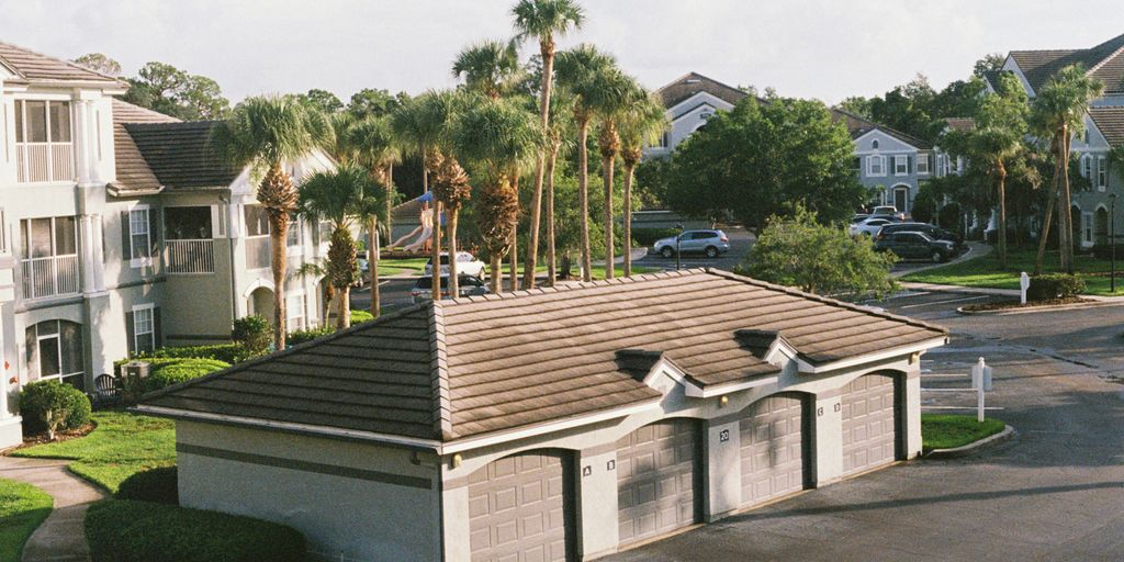 A view of a street with houses and palm trees