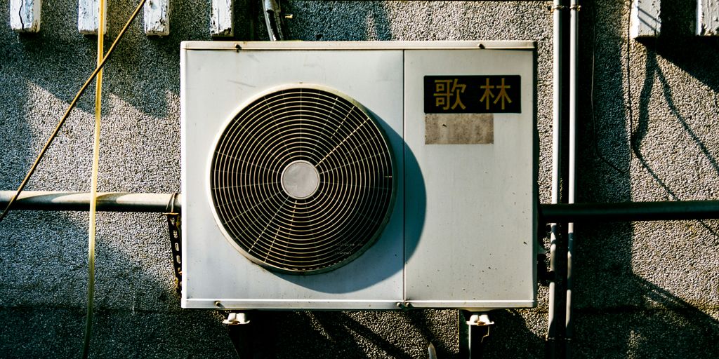 a wall mounted air conditioner mounted on the side of a building