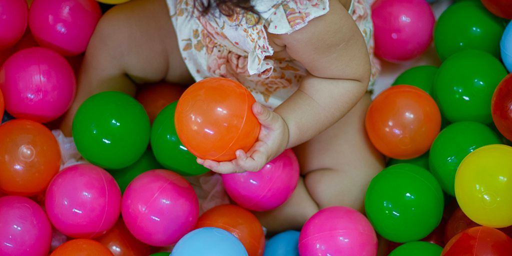 a baby is sitting in a ball pit
