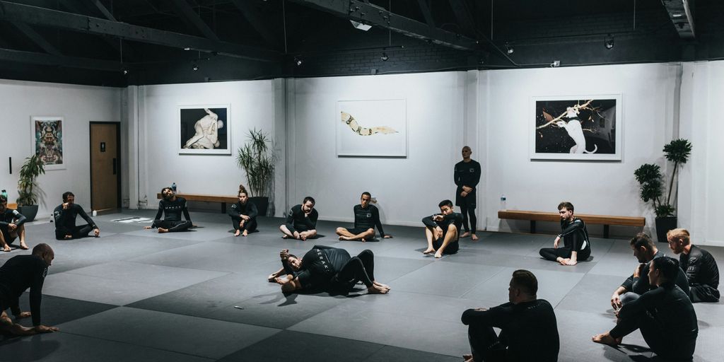 people sitting on floor in front of white wall
