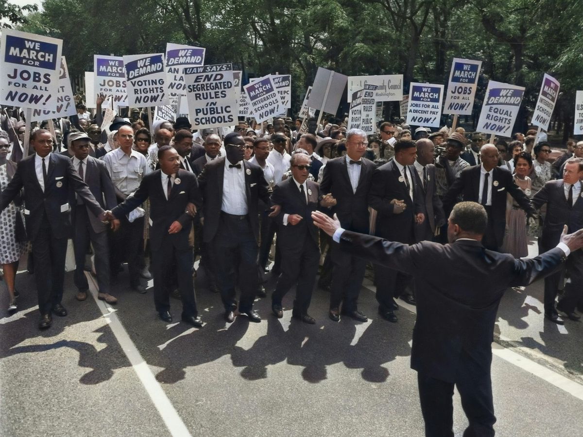 men in suit walking on street holding signages
