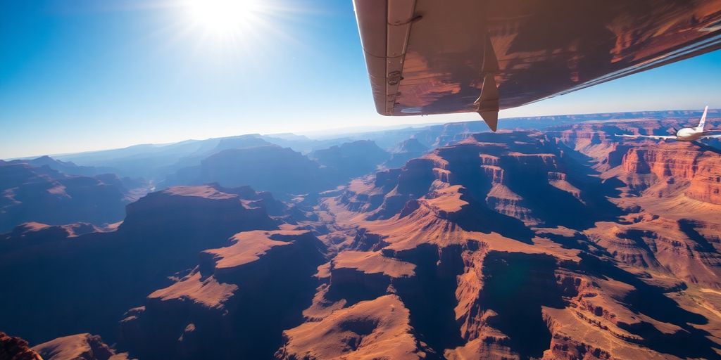 A small airplane flies over the vast Grand Canyon.