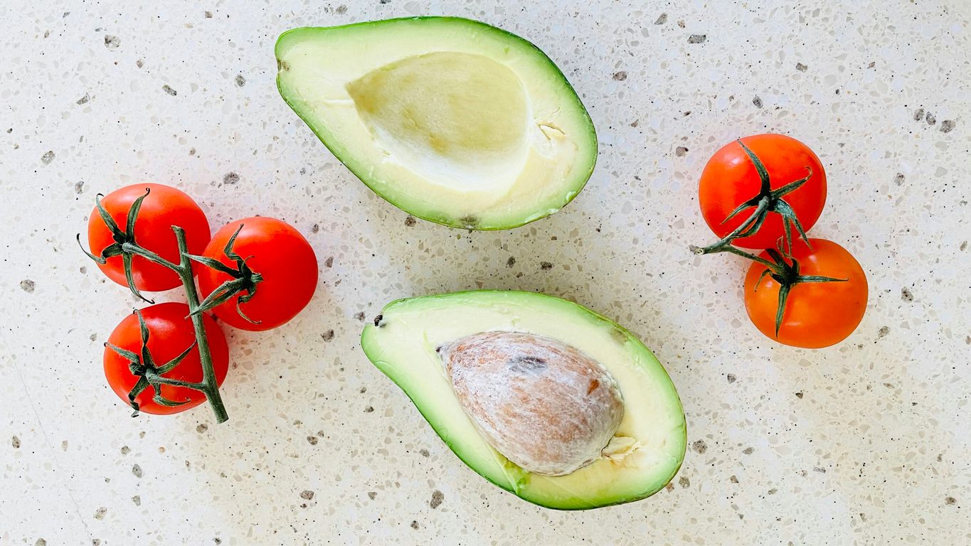 Avocado and tomatoes on a counter top