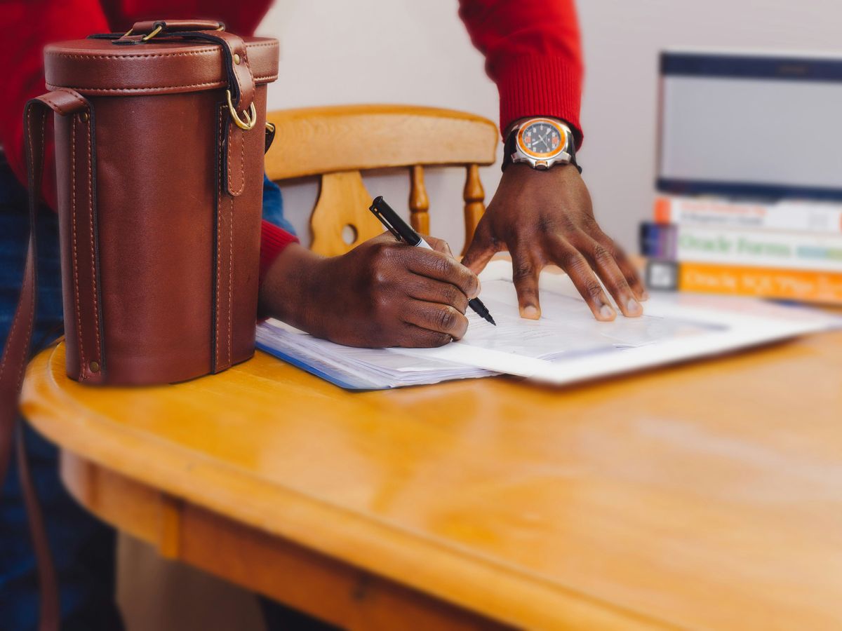 person writing on paper