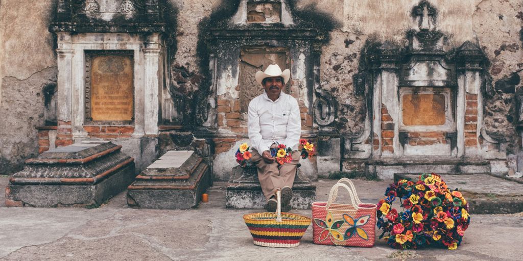 man sitting on tombstone